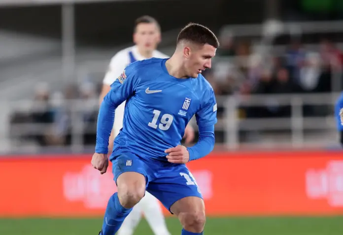 a man in a blue uniform running on a field